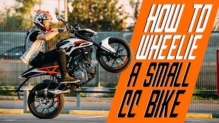 How to wheelie a small cc bike  RokON VLOG 25 [upl. by Anuaik]